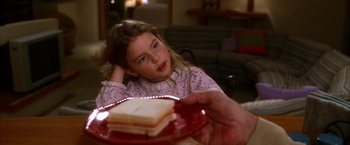 Movie still from “Kill Bill: Vol. 2” (2004), directed by Quentin Tarantino – A little girl sitting in front of a piece of cake on a plate; Close Up shot, Over the shoulder angle