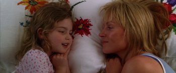 Movie still from “Kill Bill: Vol. 2” (2004), directed by Quentin Tarantino – A woman and a child laying in bed next to each other; Close Up shot, Overhead angle