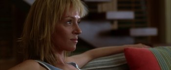 Movie still from “Kill Bill: Vol. 2” (2004), directed by Quentin Tarantino – A person sitting on a couch; Close Up shot, Low angle