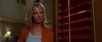 Movie still from “Kill Bill: Vol. 2” (2004), directed by Quentin Tarantino – A woman standing in front of a window with blinds; Close Up shot, Low angle