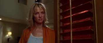 Movie still from “Kill Bill: Vol. 2” (2004), directed by Quentin Tarantino – A woman standing in front of a window with blinds; Close Up shot, Low angle