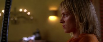 Movie still from “Kill Bill: Vol. 2” (2004), directed by Quentin Tarantino – A person looking to the side; Close Up shot, Low angle