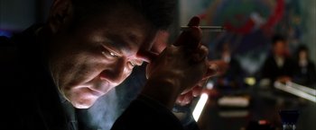 Movie still from “Kill Bill: Vol. 2” (2004), directed by Quentin Tarantino – A man is holding a cigarette in his hand; Close Up shot, Low angle