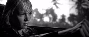 Movie still from “Kill Bill: Vol. 2” (2004), directed by Quentin Tarantino – A black and white photo of a woman in a car looking out the window; Close Up shot, Over the shoulder angle