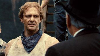 Movie still from “Kill the Irishman” (2011), directed by Jonathan Hensleigh – A man with a bandanna on his face and a man with a beard on his head; Close Up shot, Over the shoulder angle