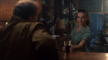 Movie still from “Kill the Irishman” (2011), directed by Jonathan Hensleigh – A woman sitting at a table in front of a man; Medium shot, Over the shoulder angle