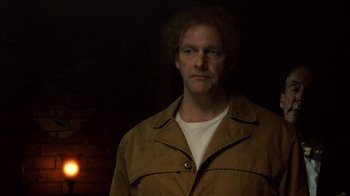 Movie still from “Kill the Irishman” (2011), directed by Jonathan Hensleigh – A man in a brown jacket standing next to a brick wall; Close Up shot, Low angle