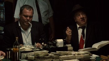 Movie still from “Kill the Irishman” (2011), directed by Jonathan Hensleigh – Two men sitting in front of a pile of money; Medium shot, High angle