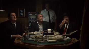 Movie still from “Kill the Irishman” (2011), directed by Jonathan Hensleigh – A group of men sitting at a table with stacks of money; Medium shot, High angle