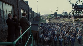 Movie still from “Kill the Irishman” (2011), directed by Jonathan Hensleigh – A large group of people standing in a yard; Extreme Wide shot, High angle