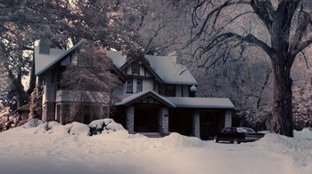 Movie still from “Kill the Irishman” (2011), directed by Jonathan Hensleigh – A house that is covered in snow near some trees; Extreme Wide shot, High angle
