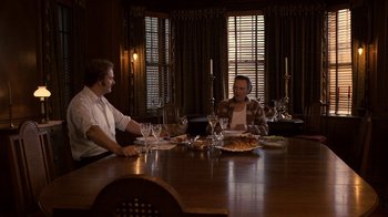 Movie still from “Kill the Irishman” (2011), directed by Jonathan Hensleigh – Two men sitting at a dinner table with wine glasses; Wide shot, High angle