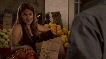 Movie still from “Kill the Irishman” (2011), directed by Jonathan Hensleigh – A woman standing in front of a pile of fruit; Close Up shot, Over the shoulder angle