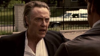 Movie still from “Kill the Irishman” (2011), directed by Jonathan Hensleigh – An older man in a black suit and white shirt; Close Up shot, Over the shoulder angle
