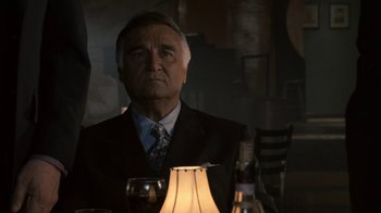 Movie still from “Kill the Irishman” (2011), directed by Jonathan Hensleigh – An older man sitting at a dinner table; Close Up shot, Low angle