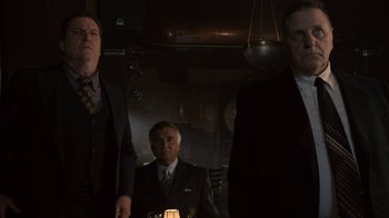 Movie still from “Kill the Irishman” (2011), directed by Jonathan Hensleigh – A group of men standing next to each other in a room; Medium shot, Low angle