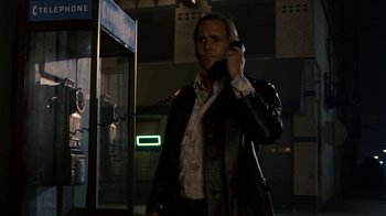 Movie still from “Kill the Irishman” (2011), directed by Jonathan Hensleigh – A man talking on a cell phone while wearing a leather jacket; Medium shot, Low angle
