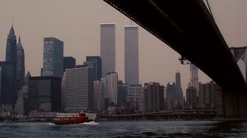 Movie still from “Kill the Irishman” (2011), directed by Jonathan Hensleigh – A red boat in the middle of a river with a city in the background; Extreme Wide shot, Low angle