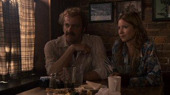 Movie still from “Kill the Irishman” (2011), directed by Jonathan Hensleigh – A man and a woman sitting at a dinner table; Medium shot, Over the shoulder angle