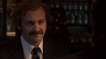 Movie still from “Kill the Irishman” (2011), directed by Jonathan Hensleigh – A person wearing a suit and tie; Close Up shot, Over the shoulder angle