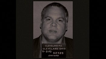 Movie still from “Kill the Irishman” (2011), directed by Jonathan Hensleigh – A black - and - white photo of a man's mugshot; Close Up shot, Overhead angle