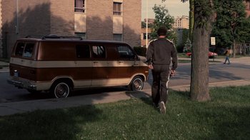 Movie still from “Kill the Irishman” (2011), directed by Jonathan Hensleigh – A man walking down the street in front of a van; Wide shot, High angle