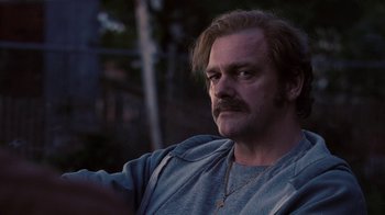 Movie still from “Kill the Irishman” (2011), directed by Jonathan Hensleigh – A person with a beard and mustache; Close Up shot, Over the shoulder angle