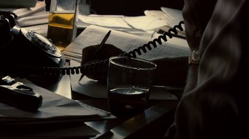 Movie still from “Kill the Irishman” (2011), directed by Jonathan Hensleigh – An image of a glass of water on a table; Extreme Close Up shot, High angle