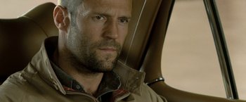 Movie still from “Killer Elite” (2011), directed by Gary McKendry – A person wearing a jacket; Close Up shot, Low angle
