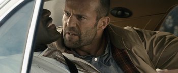 Movie still from “Killer Elite” (2011), directed by Gary McKendry – A person with a tie; Close Up shot, Over the shoulder angle