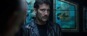 Movie still from “Killer Elite” (2011), directed by Gary McKendry – A person wearing a leather jacket; Close Up shot, Low angle