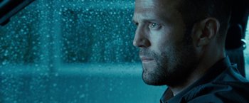 Movie still from “Killer Elite” (2011), directed by Gary McKendry – A man's face in front of a window; Close Up shot, Low angle