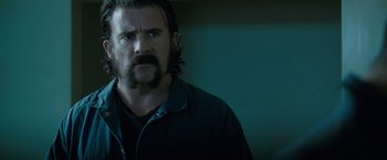 Movie still from “Killer Elite” (2011), directed by Gary McKendry – A person with a beard; Close Up shot, Over the shoulder angle