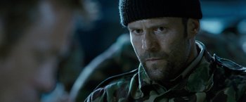 Movie still from “Killer Elite” (2011), directed by Gary McKendry – A person wearing a hat; Close Up shot, Low angle