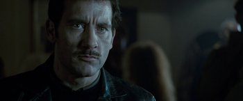 Movie still from “Killer Elite” (2011), directed by Gary McKendry – A person with a mustache; Close Up shot, Low angle