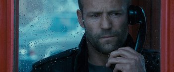 Movie still from “Killer Elite” (2011), directed by Gary McKendry – A person with wet glass; Close Up shot, Over the shoulder angle