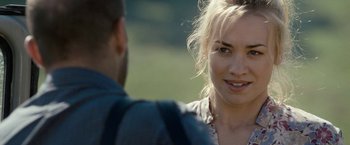 Movie still from “Killer Elite” (2011), directed by Gary McKendry – A man and a woman talking to each other outside; Close Up shot, Over the shoulder angle