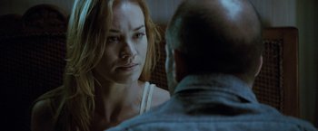 Movie still from “Killer Elite” (2011), directed by Gary McKendry – A woman is looking at an older man; Close Up shot, Over the shoulder angle