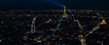 Movie still from “Killer Elite” (2011), directed by Gary McKendry – A view of the eiffel tower at night from above; Extreme Wide shot, High angle