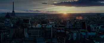 Movie still from “Killer Elite” (2011), directed by Gary McKendry – The sun is setting over a large city; Extreme Wide shot, High angle