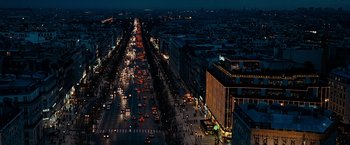 Movie still from “Killer Elite” (2011), directed by Gary McKendry – An aerial view of a busy city at night; Extreme Wide shot, High angle