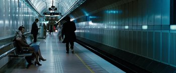 Movie still from “Killer Elite” (2011), directed by Gary McKendry – A man walking down a train platform holding a bag; Wide shot, High angle