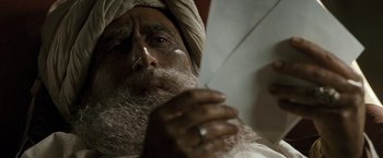 Movie still from “Killer Elite” (2011), directed by Gary McKendry – An old man with a beard is holding a toothbrush; Close Up shot, Low angle