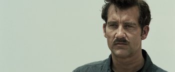 Movie still from “Killer Elite” (2011), directed by Gary McKendry – A person with a mustache; Close Up shot, Low angle