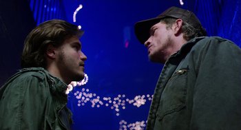 Movie still from “Killer Joe” (2011), directed by William Friedkin – Two men standing next to each other on a street; Close Up shot, Over the shoulder angle