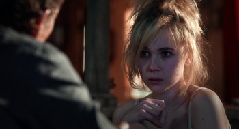 Movie still from “Killer Joe” (2011), directed by William Friedkin – A young woman looking into a mirror while holding her hand to her chest; Close Up shot, Over the shoulder angle