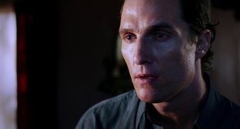 Movie still from “Killer Joe” (2011), directed by William Friedkin – A man's face in a dark room; Close Up shot, Over the shoulder angle