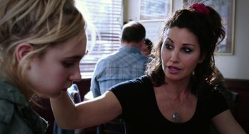 Movie still from “Killer Joe” (2011), directed by William Friedkin – A woman sitting next to another woman in a restaurant; Close Up shot, Over the shoulder angle