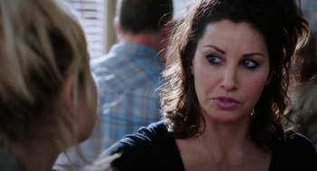 Movie still from “Killer Joe” (2011), directed by William Friedkin – A person sitting down looking sad; Close Up shot, Over the shoulder angle