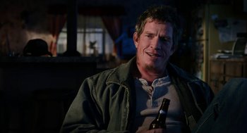 Movie still from “Killer Joe” (2011), directed by William Friedkin – A person holding a bottle of beer; Close Up shot, Over the shoulder angle